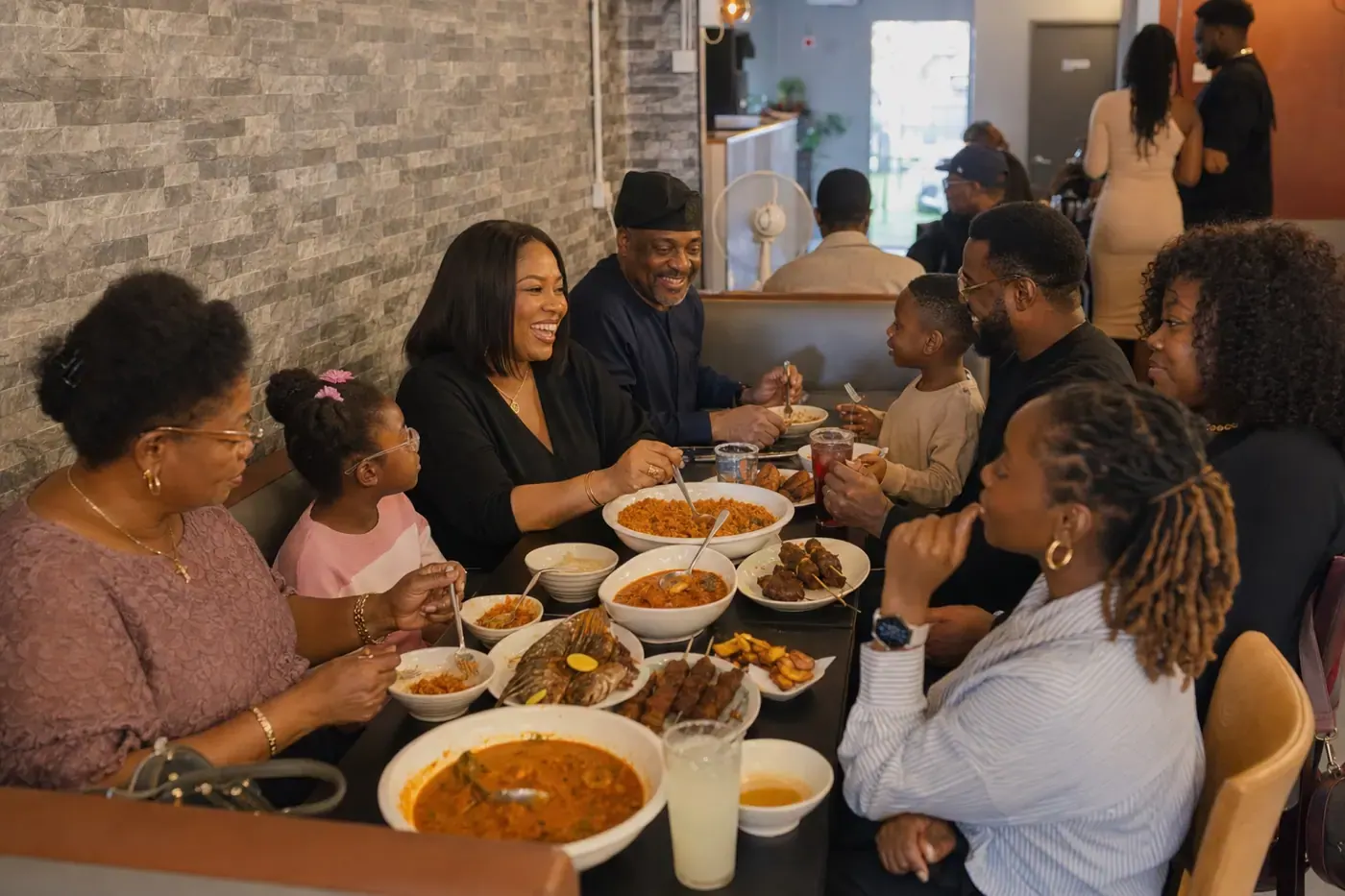 Family and friends sharing West African food on Sunday at 042